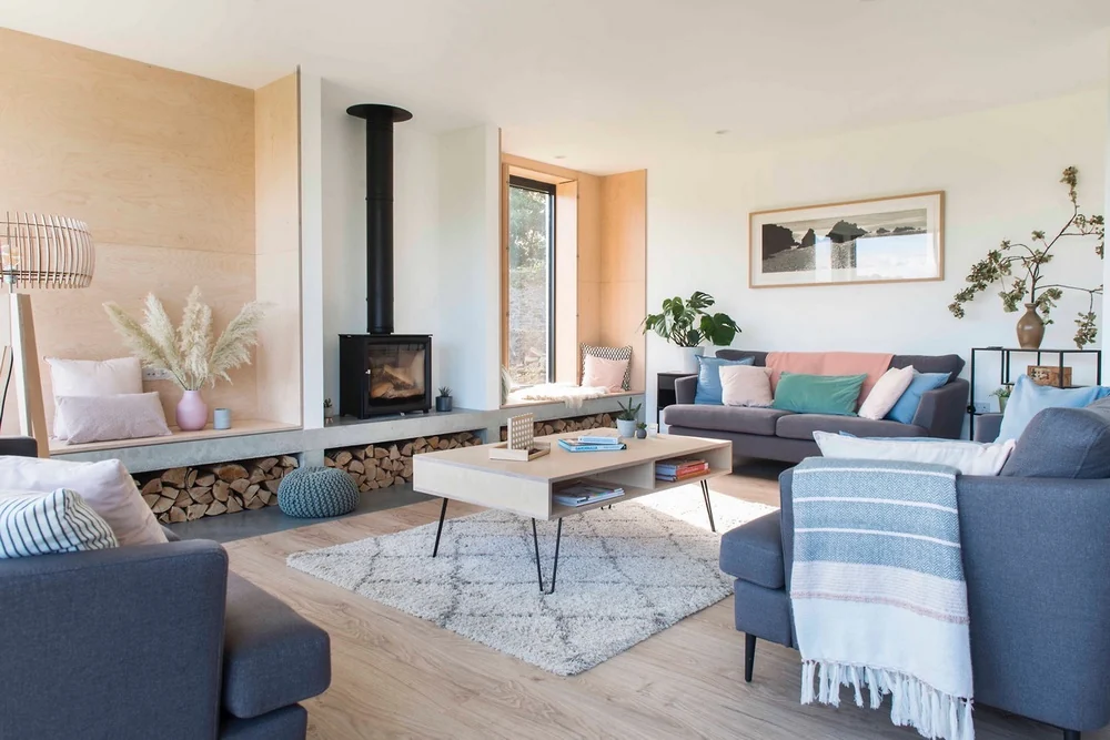 Living room with bespoke fireplace, log store and seating