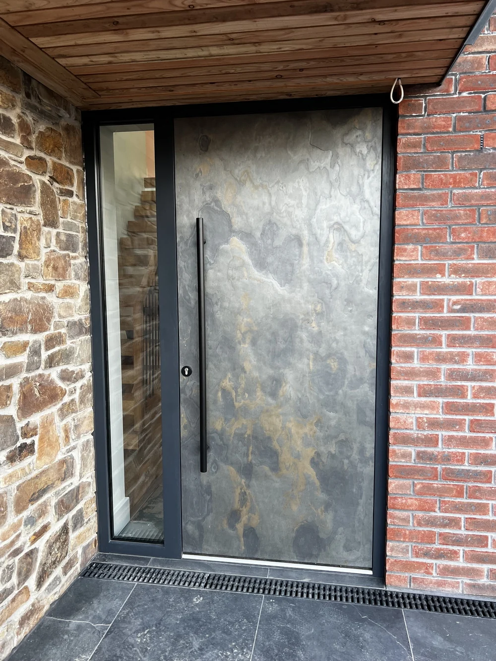 Entrance door with stone, slate and brick detailing